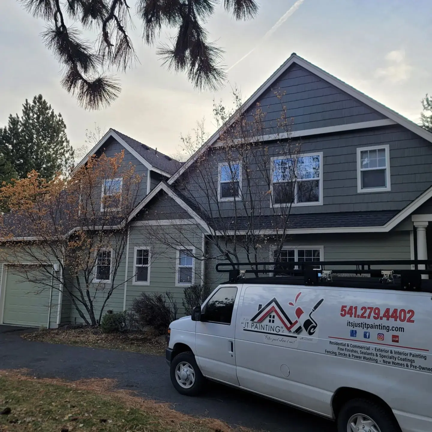Completed exterior painting project in Bend OR with the company van parked in front.