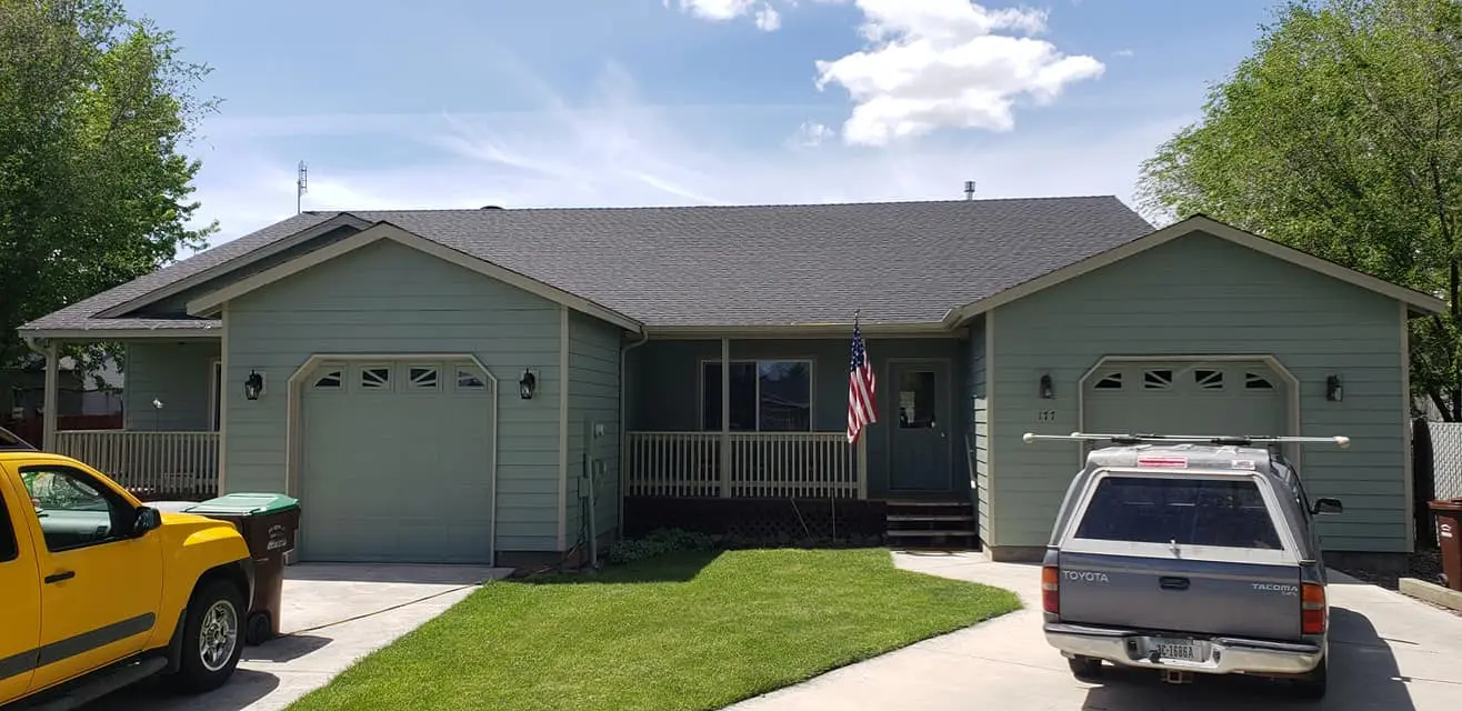 Front view of a residential duplex in Prineville featuring Miller Paint Evolution in sage green.