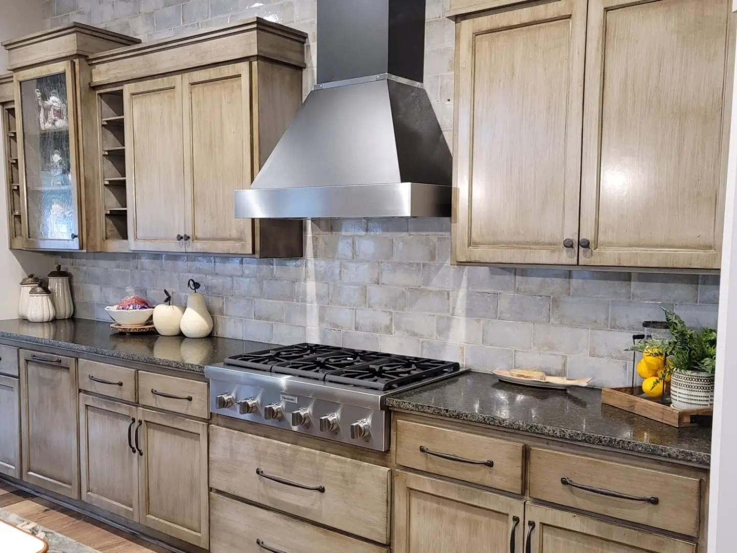 Kitchen perimeter cabinets finished with Miller Rudd pigmented lacquer and stainless steel range hood.