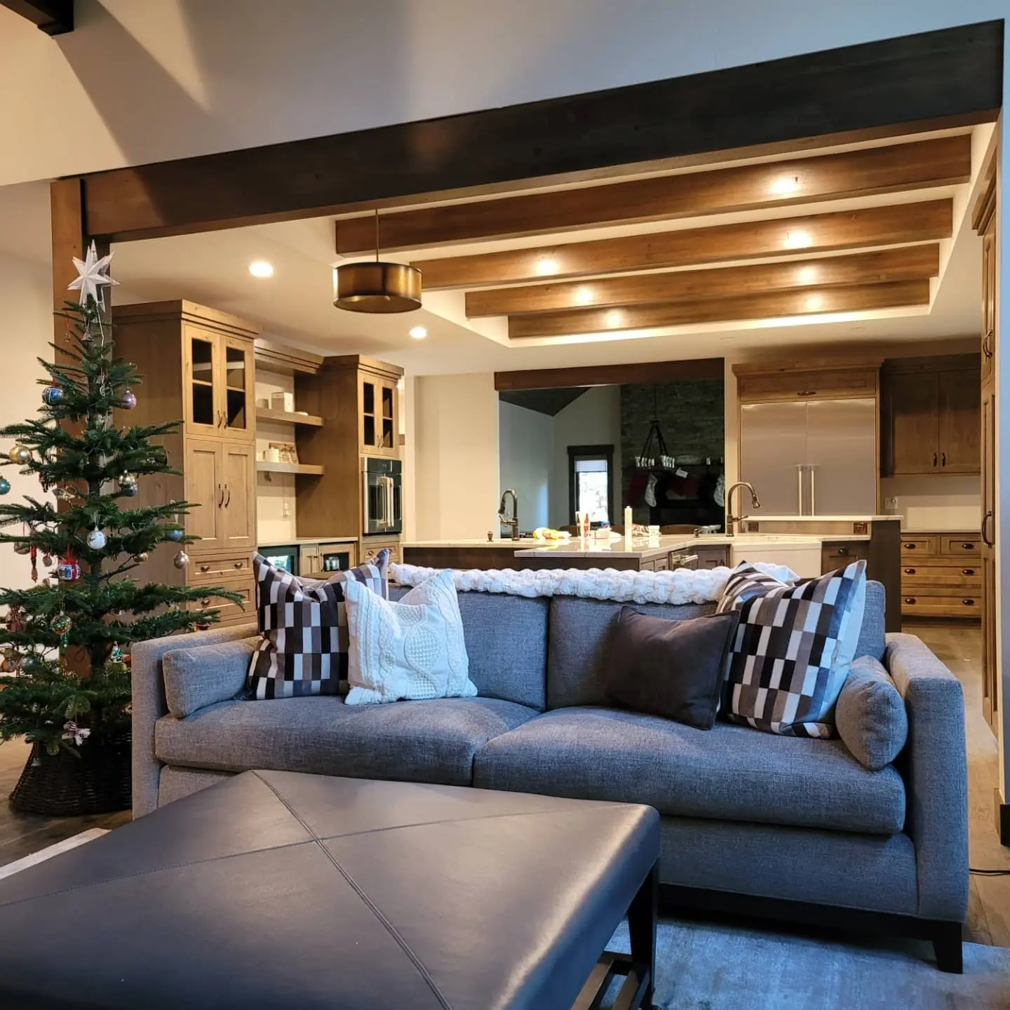 Bright interior living space in Sunriver, Oregon, with white walls, dark wood accents, and a festive holiday setup.