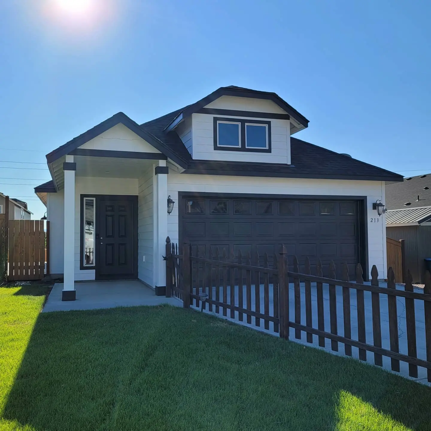 Front exterior of a Redmond home with fresh white siding and bold black trim accents.
