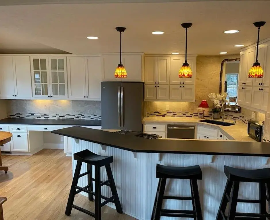 Completed kitchen remodel in Sisters OR featuring white pigmented lacquer cabinets and a beadboard island.
